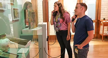 Students listen to audio clip in gallery
